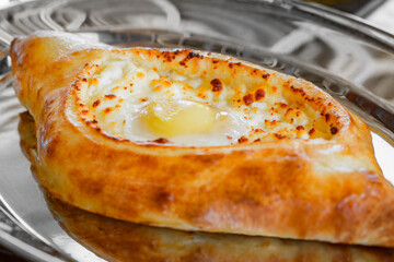 Adzharian khachapuri with raw egg, selective focus