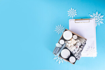 Winter cold and flu viruses therapy and treatment. Box with first aid kit medicines, pills, sprays...