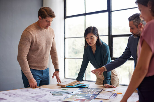 Group of architects discussing project during meeting
