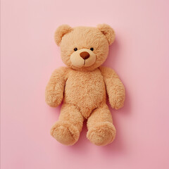 Obraz premium A cozy brown teddy bear sits upfront on a soft pastel pink backdrop, perfect for adding warmth to any space.