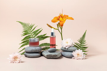 cosmetics containers on a stone podium surrounded by chrysanthemum flowers and fern leaves