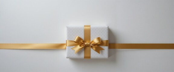 Elegant gift box with gold ribbon on a white background.
