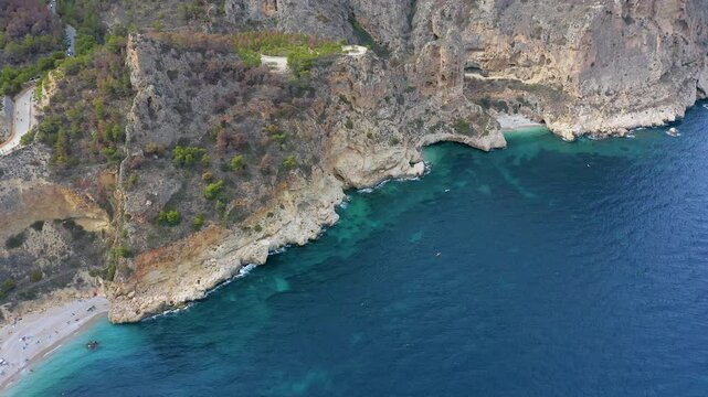 Aerial view of the wonderful Cala del Moraig and Cala de los Tiestos, located between the beautiful cliffs of the town of Benitachell, in the Mediterranean province of Alicante, Spain.