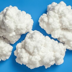 Fluffy White Clouds on Vivid Blue Background Studio Shot