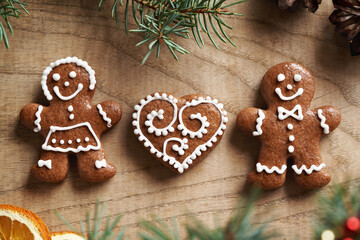 Man, woman and heart shaped homemade gingerbread Christmas cookies decorated with white icing. Love concept.