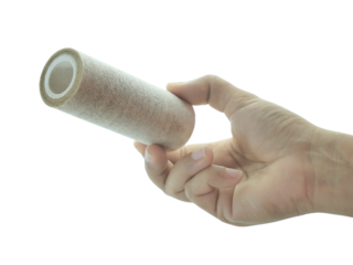 Female hand holding Used water filter isolated on white background.