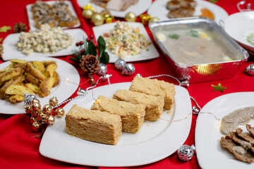 Slices of layered honey cake (Medovik, Napoleon) with a golden crumb coating served on a festive...