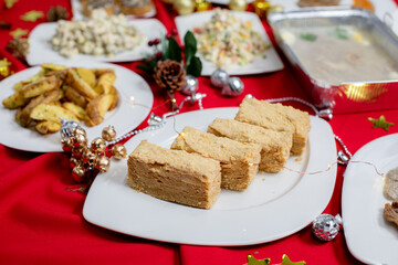 Slices of layered honey cake (Medovik, Napoleon) with a golden crumb coating served on a festive...