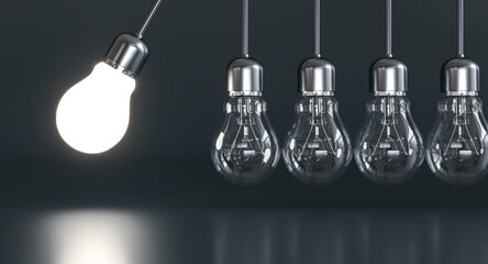 Lit light bulb swinging and transferring energy to other