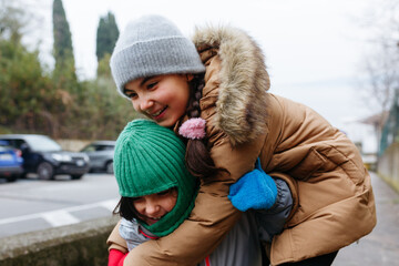 two happy girls hugging each other