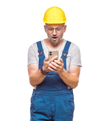 Unexpected message on smart phone. Surprised middle-aged construction worker with phone browsing,...