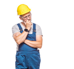 Pensive middle-aged construction worker feeling doubtful, copy space for text, isolated on white background. Repairman thinking. Copy space. Craftsman against white wall