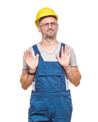 Construction worker gesturing stop sign with palm of hand, refuses or reject something, isolated on white background. Craftsman against white wall