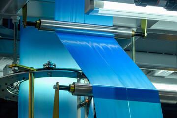 The blue plastic bags manufacturing process by automatic system.