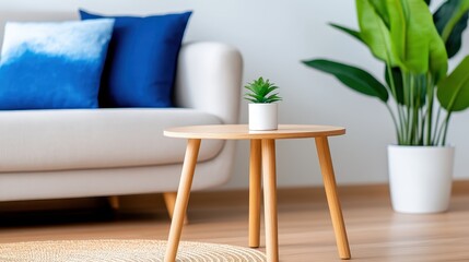 The image depicts a minimalist living room with a sleek wooden table, potted plant, and a cozy sofa adorned with blue cushions, creating a serene ambiance.