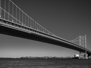 The Ben Franklin Bridge built in 1926 spanning between Philadelphia PA and Camden New Jersey on a beautiful blue sky afternoon