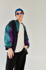 Confident young man showcases fashion in a studio setting during college years.