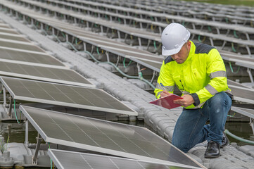 Engineer working at floating solar farm,checking and maintenance with solar batteries near solar panels,supervisor Check the system at the solar power station