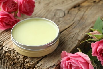 Natural solid perfume and pink roses on wood, closeup