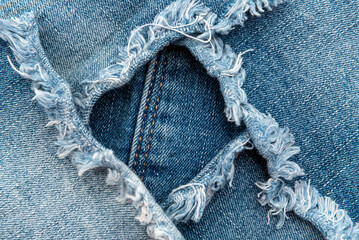 Piece of torn denim on a white background. Denim texture