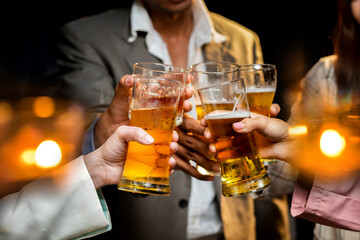 food and drink male friends are happy drinking beer and clinking glasses at a bar or pub.