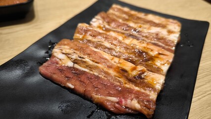 Korean style grilled beef on a black plate