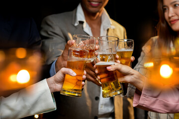 food and drink male friends are happy drinking beer and clinking glasses at a bar or pub.