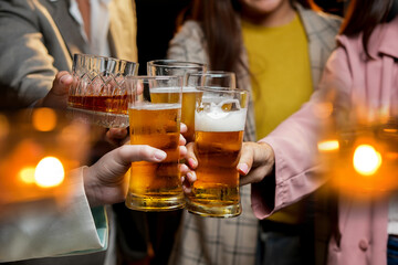 food and drink male friends are happy drinking beer and clinking glasses at a bar or pub.