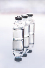 Set of transparent medical glass bottles of liquid