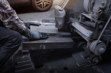 Paving workers are using a cutting machine to cut paving materials