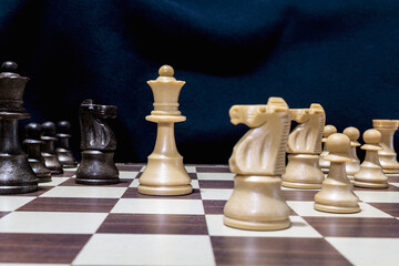 Chessmen photographed on a chessboard with a dark background