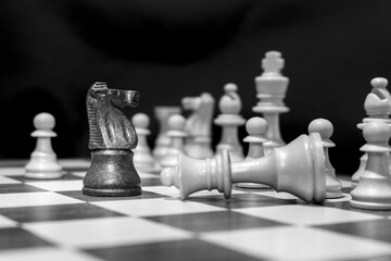 Chessmen photographed on a chessboard with a dark background