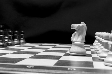 Chessmen photographed on a chessboard with a dark background