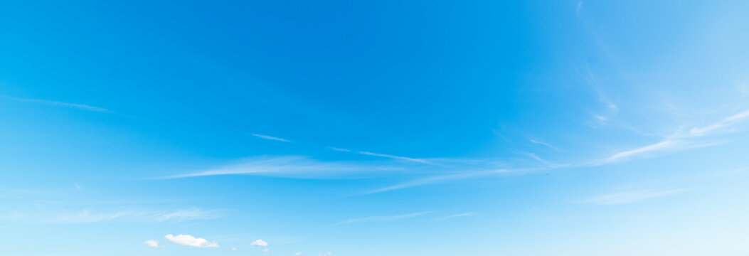 Small white clouds and blue sky - Powered by Adobe