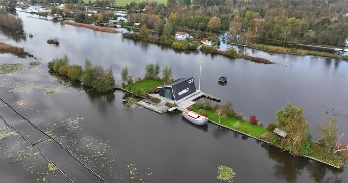 Ascending drone footage of a small house on Loosdrechtse plassen lake, near Scheendijk, Netherlands
