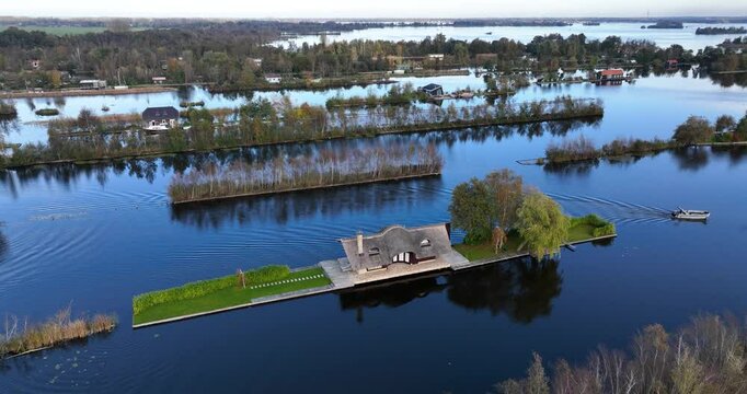 Drone footage of a small house on Loosdrechtse plassen lake, near Scheendijk hamlet, Netherlands