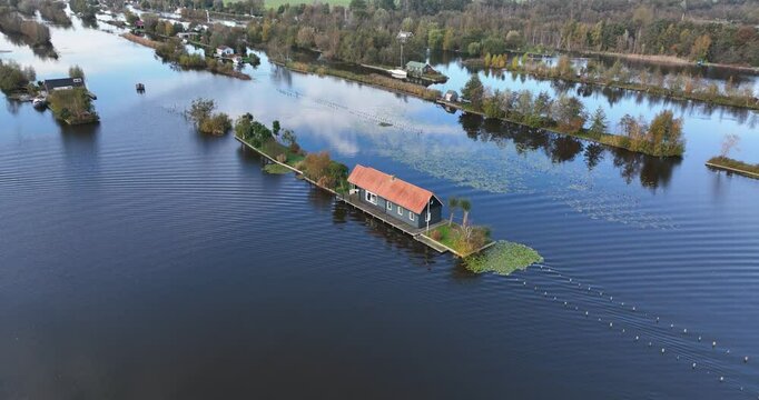 Aerial footage of a small house on Loosdrechtse plassen lake, near Scheendijk hamlet, Netherlands