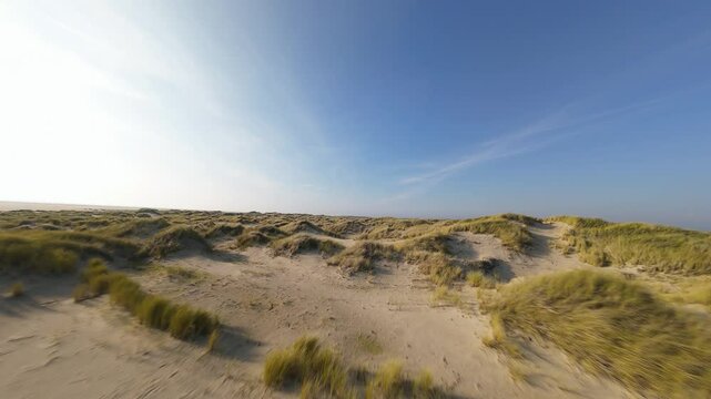 Drone footage of the Dunes of Texel National Park, on a sunny day, in De Koog, Texel, Netherlands