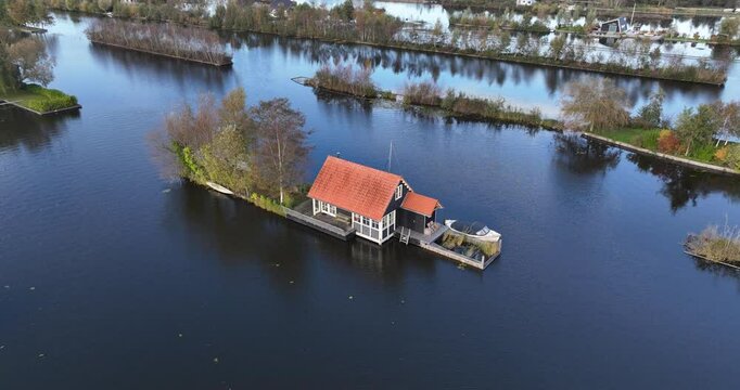 Aerial footage of a small house on Loosdrechtse plassen lake, near Scheendijk hamlet, Netherlands