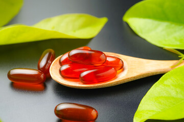 wooden spoon with soft gels, Fish oil capsules, omega 3, omega 9, vitamin D, vitamin E