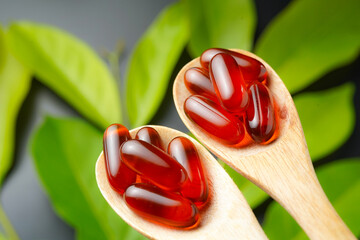 wooden spoon with soft gels, Fish oil capsules, omega 3, omega 9, vitamin D, vitamin E