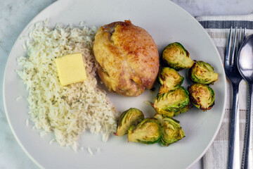boneless pork chop  on rice with  roasted brussel sprouts