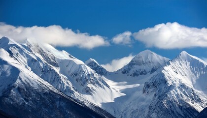 Obraz premium majestic snow covered mountain range with clear blue sky and rolling clouds