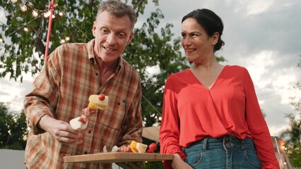 Family all together camp in garden, Old couple grill food for family member. Outdoor camping...