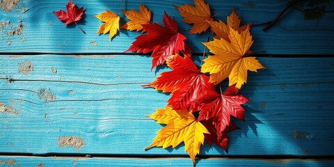 Autumn leaves on a blue wooden surface, capturing the beauty of seasonal change and the rustic charm of natural textures.