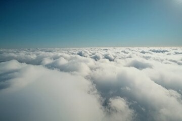 Naklejka premium A close-up view of white clouds against a blue sky, highlighting high cumulus clouds in azure skies, capturing a beautiful aerial cloudscape from above, featuring a sunny heaven landscape with a