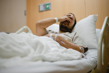 A male influenza patient is stressed about his symptoms.