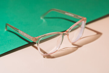 Pink eyeglasses on pastel background. Myopia.