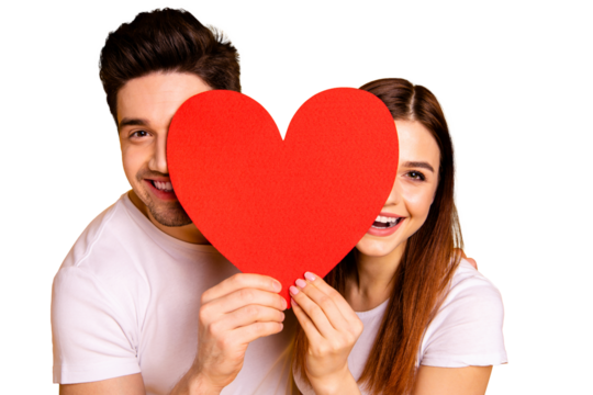 Close up photo beautiful she her he him his guy lady hiding facial expression laugh laughter hold hands arms heart shape paper postcard in love wear casual white t-shirts isolated yellow background - Powered by Adobe