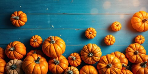 A vibrant arrangement of pumpkins resting on a rustic blue wooden surface, showcasing the beauty of autumn's bounty.